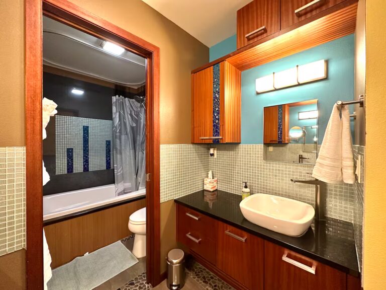 Bathroom vanity with a vessel sink and wood cabinetry at H5 Blue Lagoon of Kona Estate