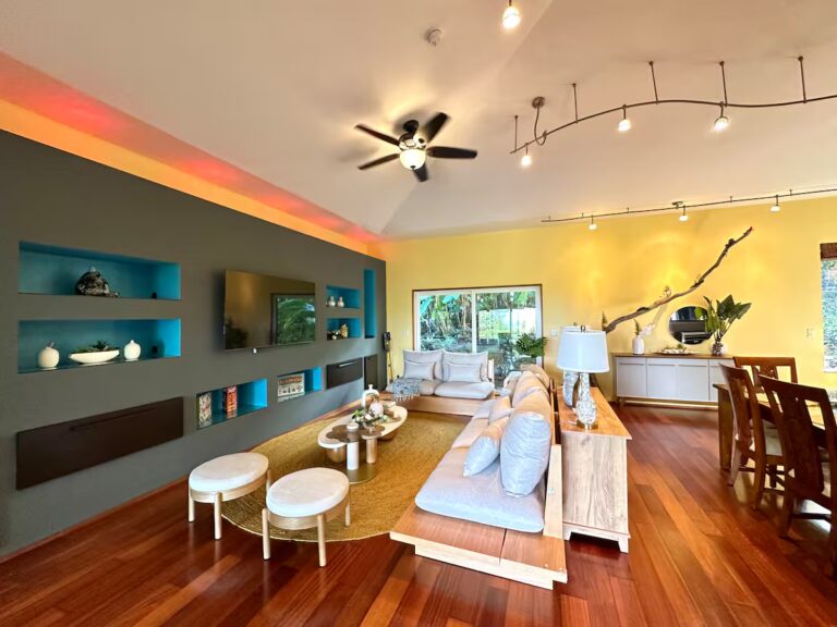 Living area with turquoise shelves and a curved sofa at H5 Blue Lagoon of Kona Estate