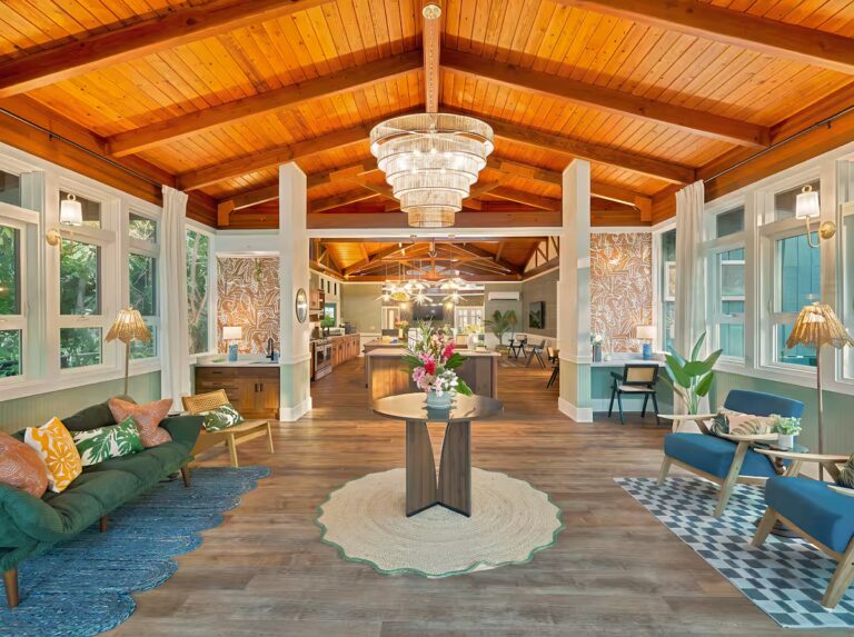 Long living space with several seating areas beneath a vaulted wood ceiling at Spacious Kona Retreat