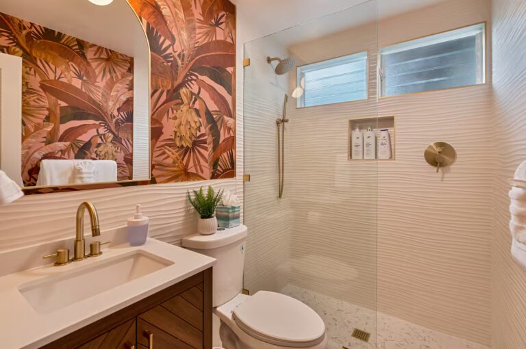 Bathroom with tropical artwork and a glass shower at Spacious Kona Retreat