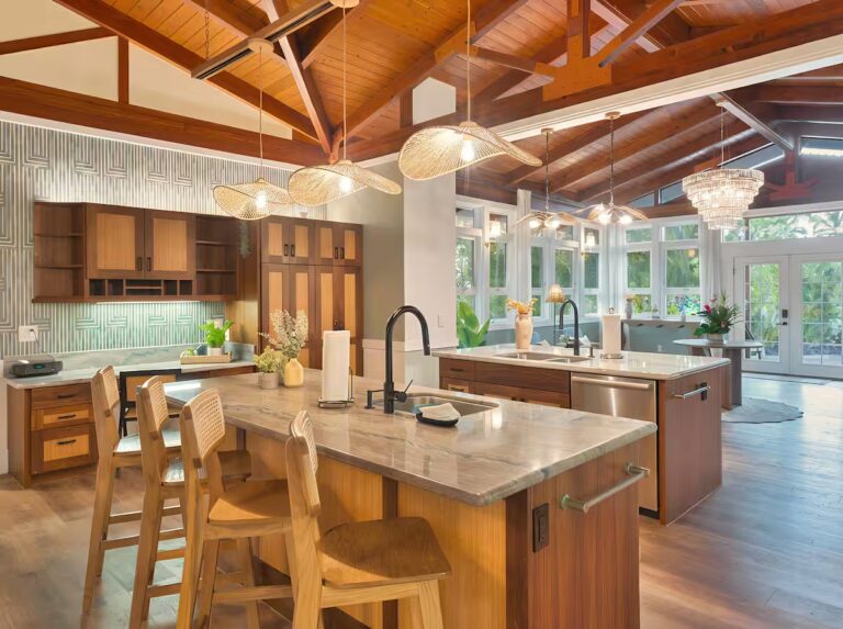 Kitchen island with seating and pendant lights at Spacious Kona Retreat