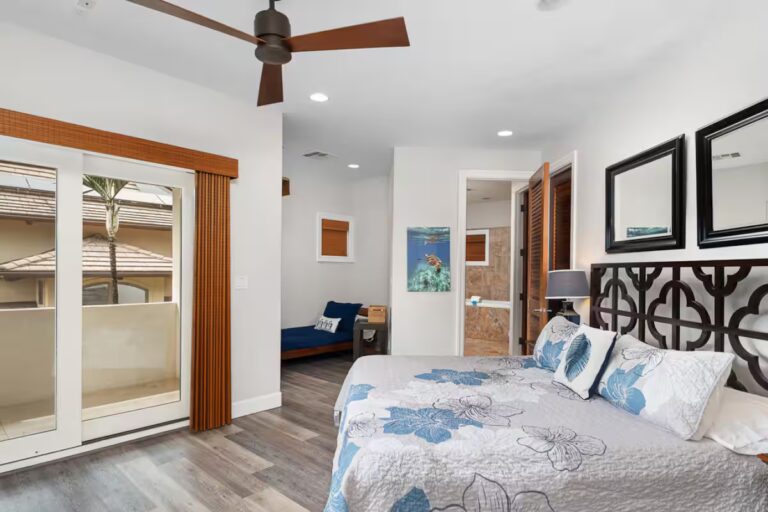 Bedroom with a dark decorative headboard and sliding doors at Kona Luxury Estate