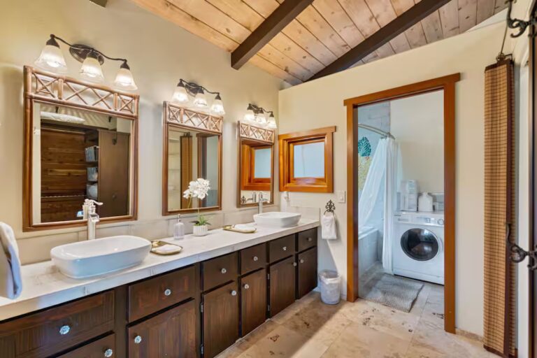 Double-sink bathroom beneath a timber ceiling at H4 Kona home