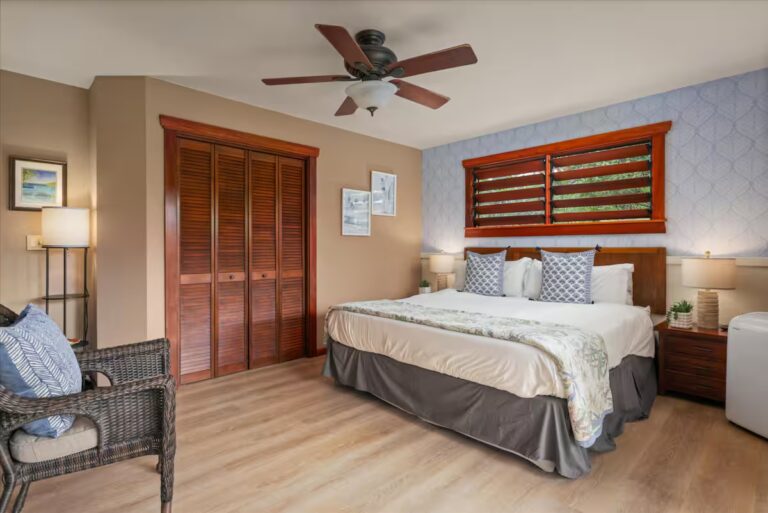 Bedroom with wood blinds and a patterned accent wall at H6 Dolphin Bay Estate