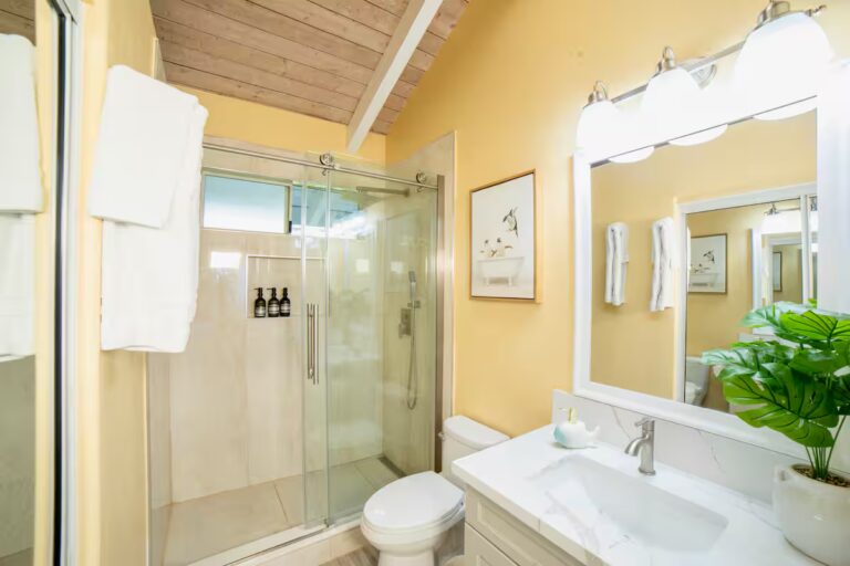 Bathroom with a glass shower and white vanity at H7 Kona home