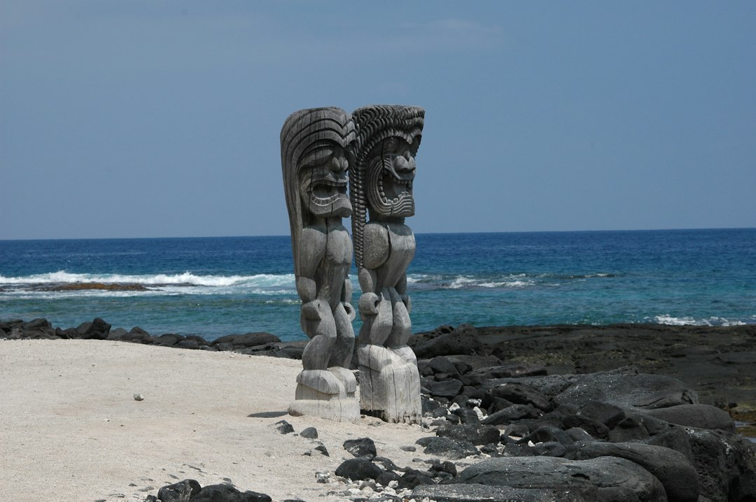 Carved figures beside a coastal Hawaiian cultural site