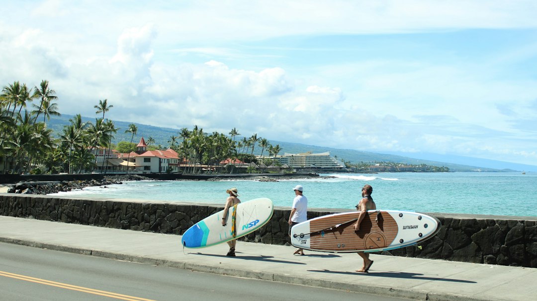 Paddleboarders walking beside the Kailua-Kona waterfront