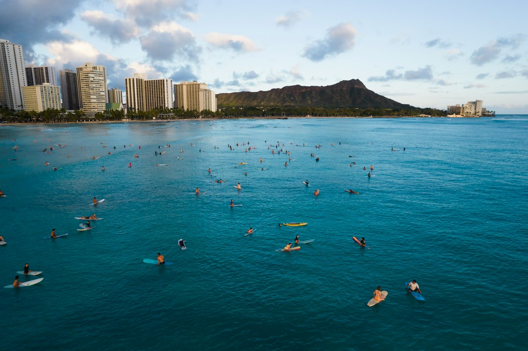 Swimmers off Waikiki beside Honolulu buildings