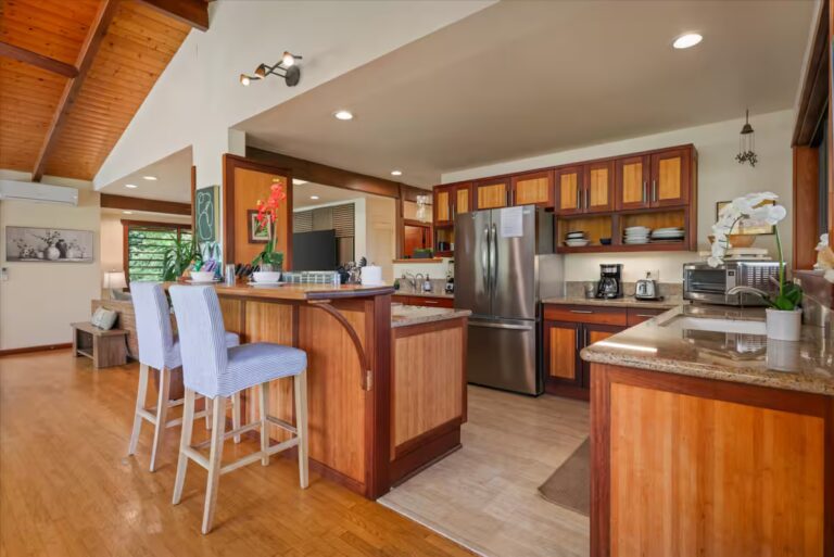 Wood kitchen with island seating and stainless-steel appliances at H6 Dolphin Bay Estate