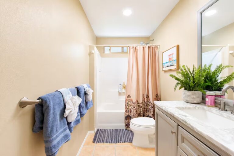 Bathroom with a long vanity and shower over the tub at Kona Retreat with Hot Tub, Tiki Bar and Pickleball