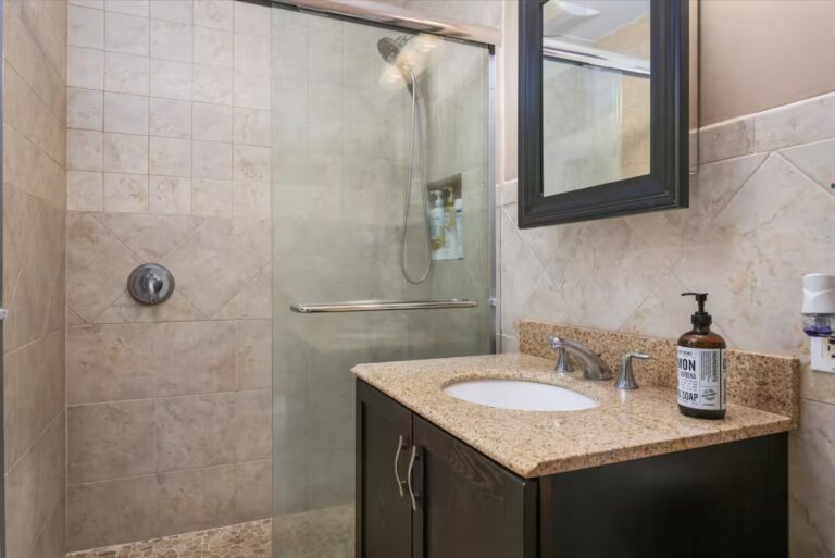 Bathroom with a glass shower and dark vanity cabinet at H6 Dolphin Bay Estate