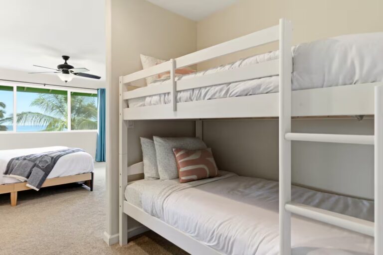 White bunk beds in an adjoining sleeping area at H12 Kona home