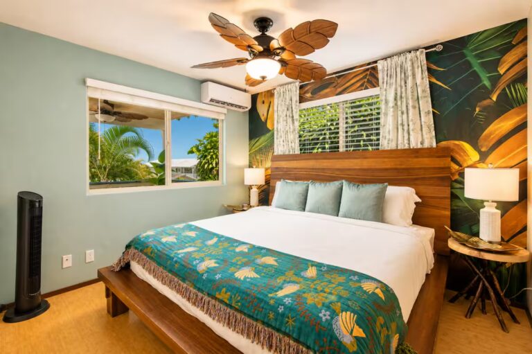 Bedroom with turquoise bedding and a tropical leaf mural at Kona Retreat with Hot Tub, Tiki Bar and Pickleball