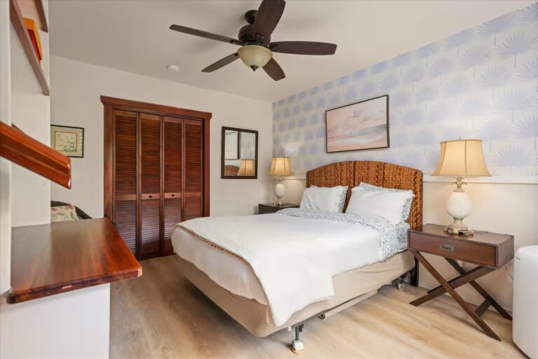 Bedroom with a woven headboard and wood closet doors at H6 Dolphin Bay Estate