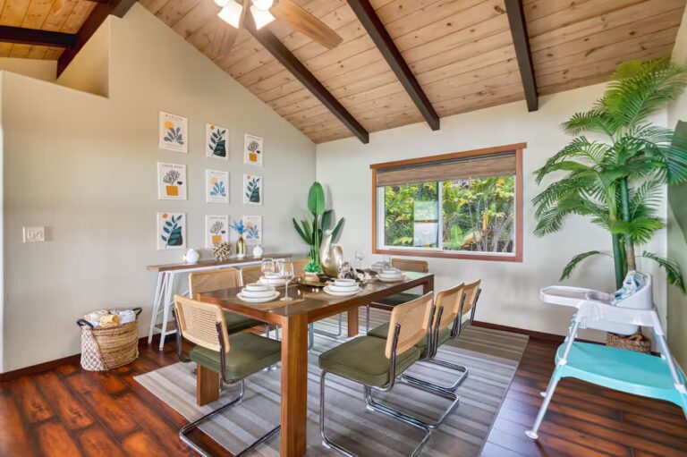 Dining table beneath an exposed wood ceiling at H4 Kona home